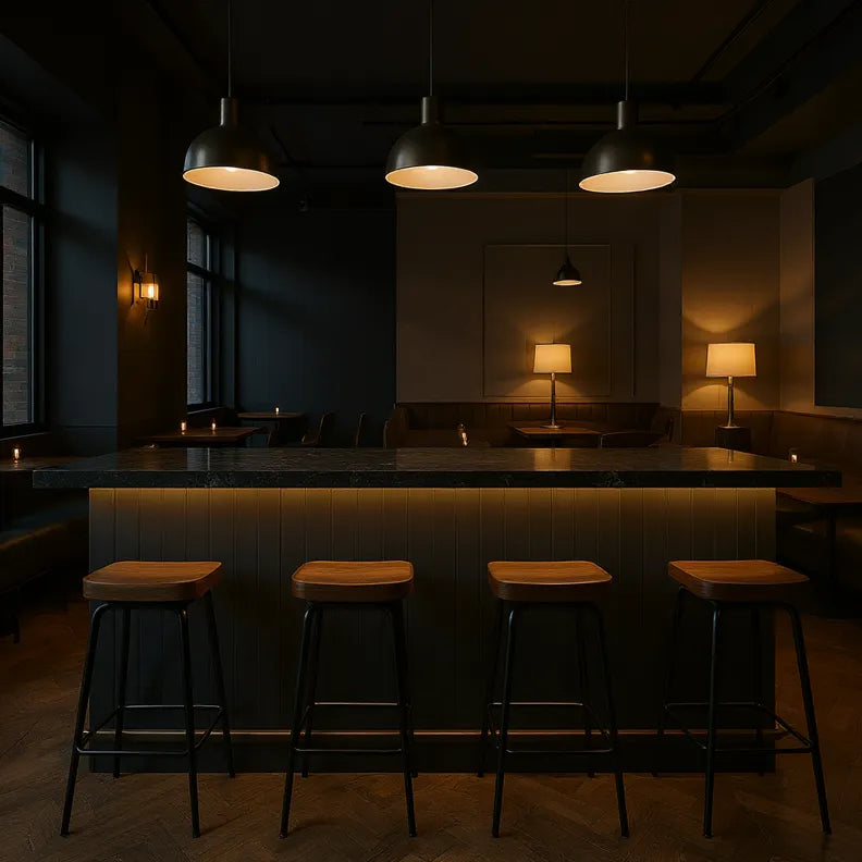 Dark interior of a bar with wooden stools and dim lighting with butt and bead style panelling on the barfront