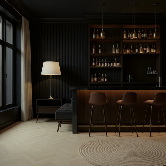 Modern bar interior with dark wood shelves, bar stools, and a lamp.