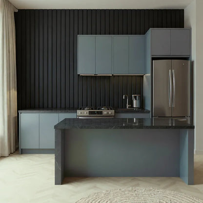 Modern kitchen with dark vertical ribbed wall panels, grey cabinets, black marble countertop, and stainless steel appliances.